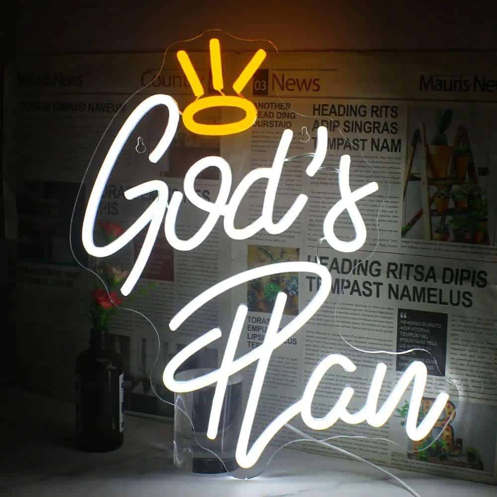 Neon sign reading "God's Plan" with a crown illustration, displayed indoors.