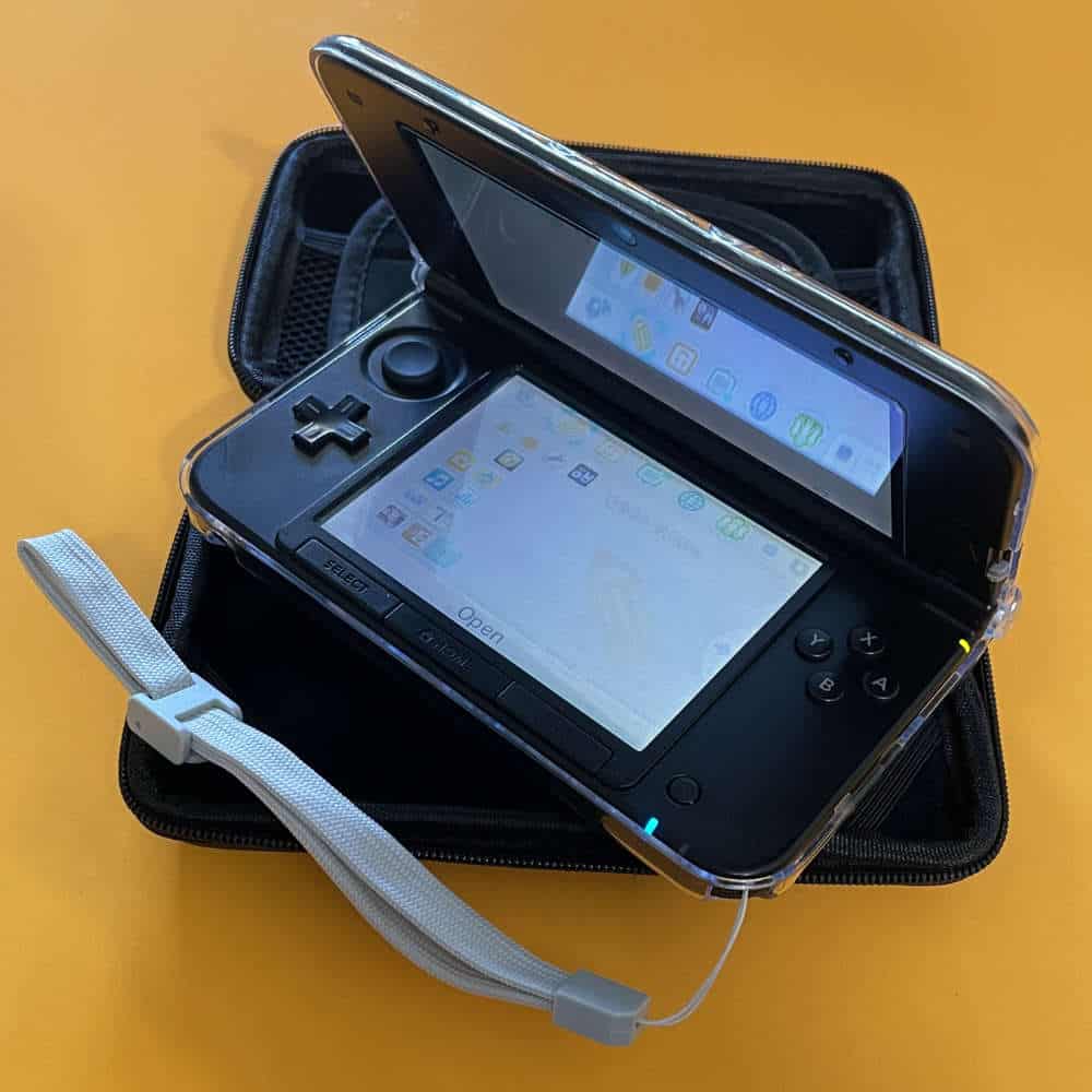 Protective case for Nintendo 3DS XL with screen protector and accessories.
