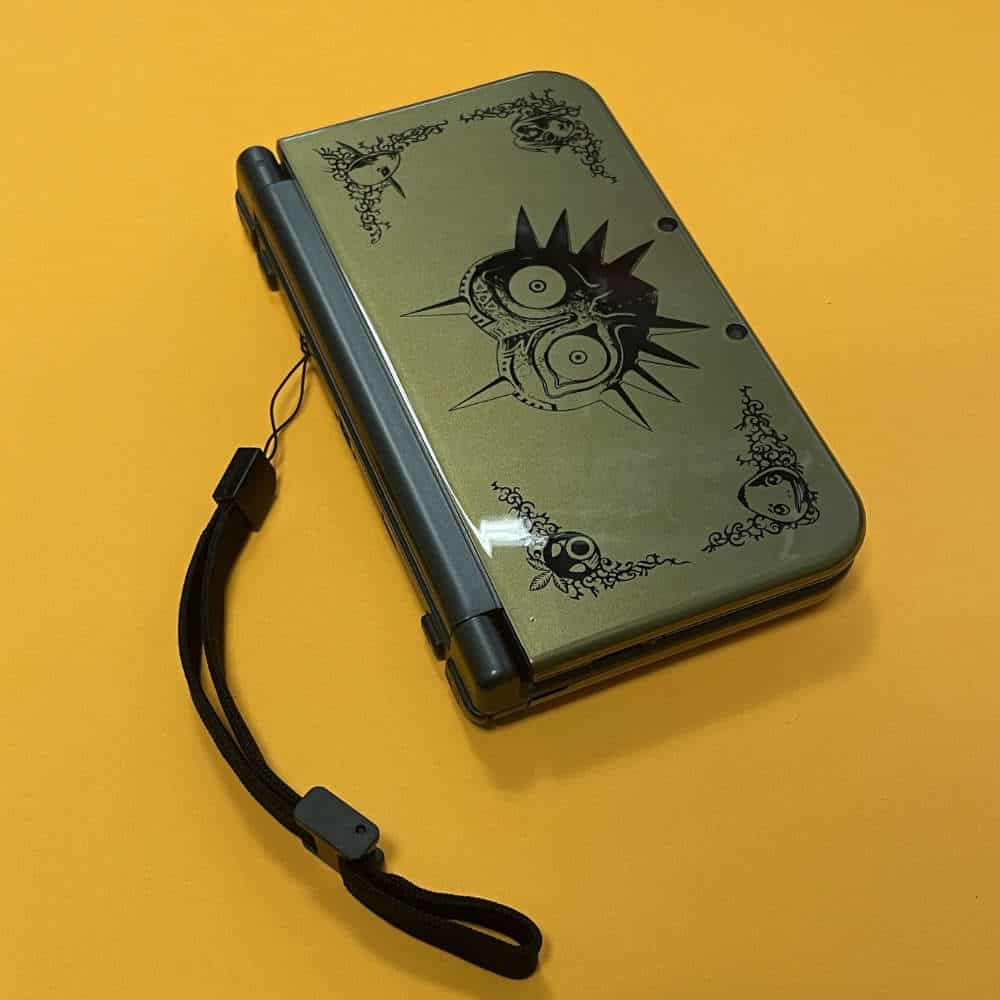 Custom protective case for New 3DS XL with unique design and wrist strap.