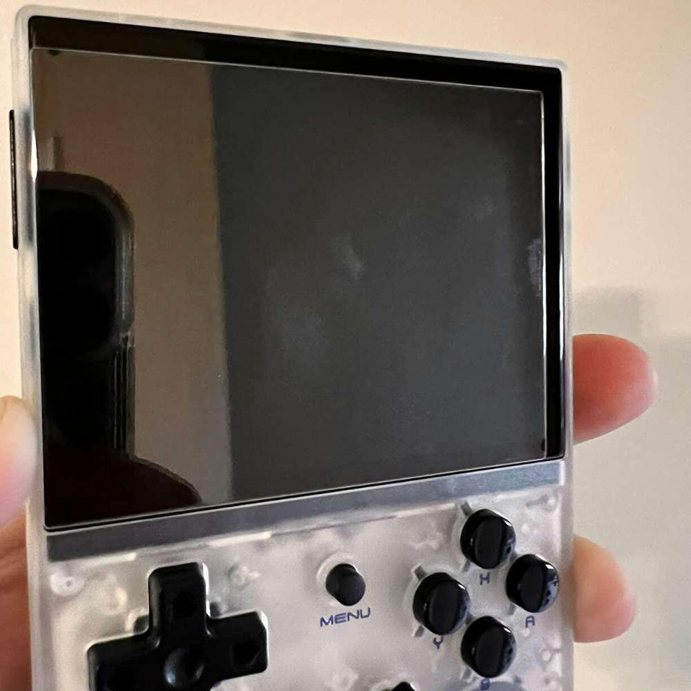 Handheld gaming device featuring a color display and multiple control buttons.