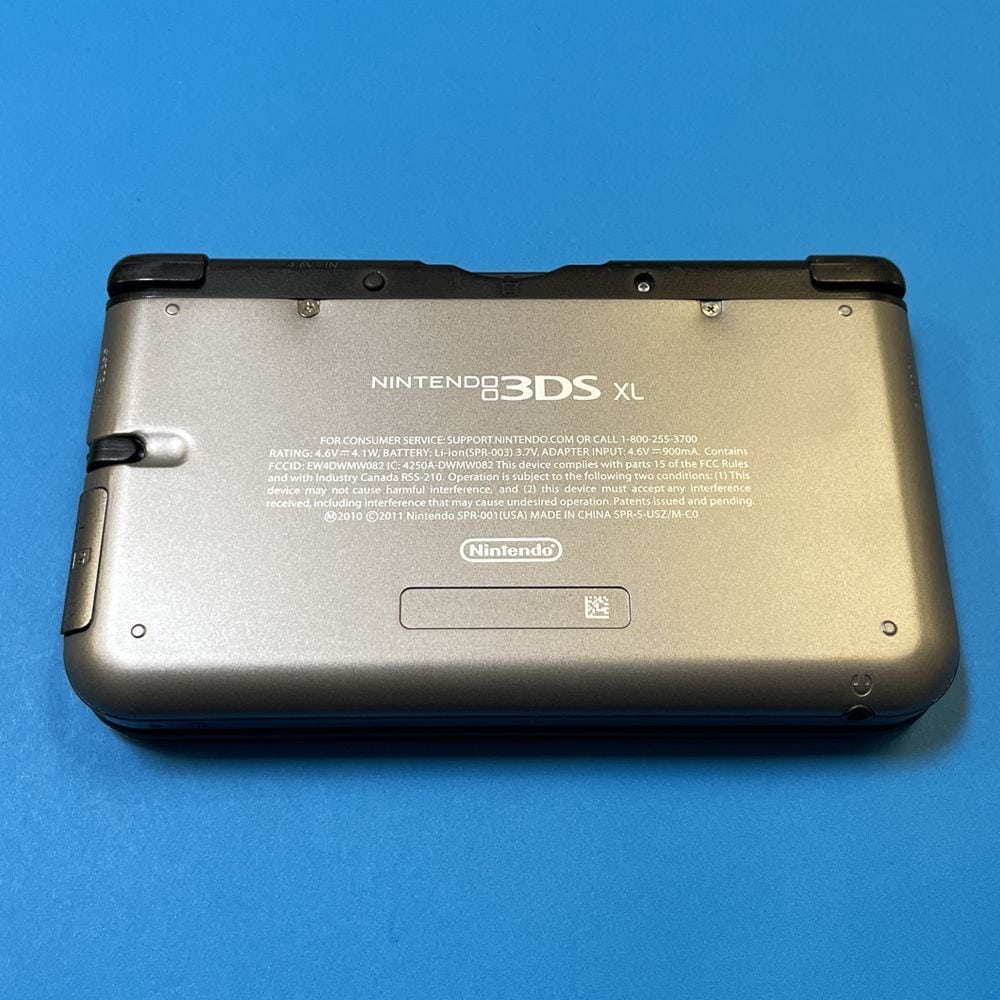 High-quality image of a Nintendo 3DS XL gaming console on a blue background.