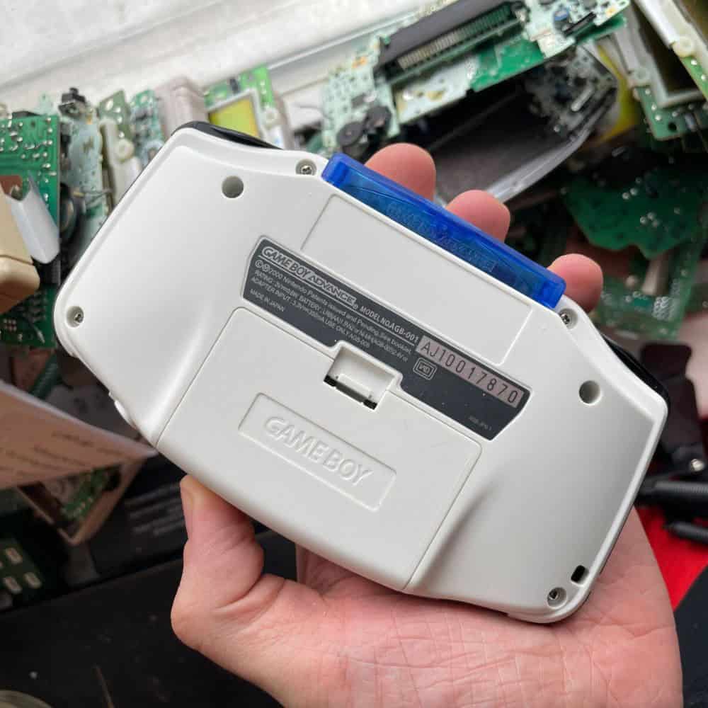 White Game Boy Advance console with IPS backlit screen upgrade. Perfect for gaming enthusiasts and c.