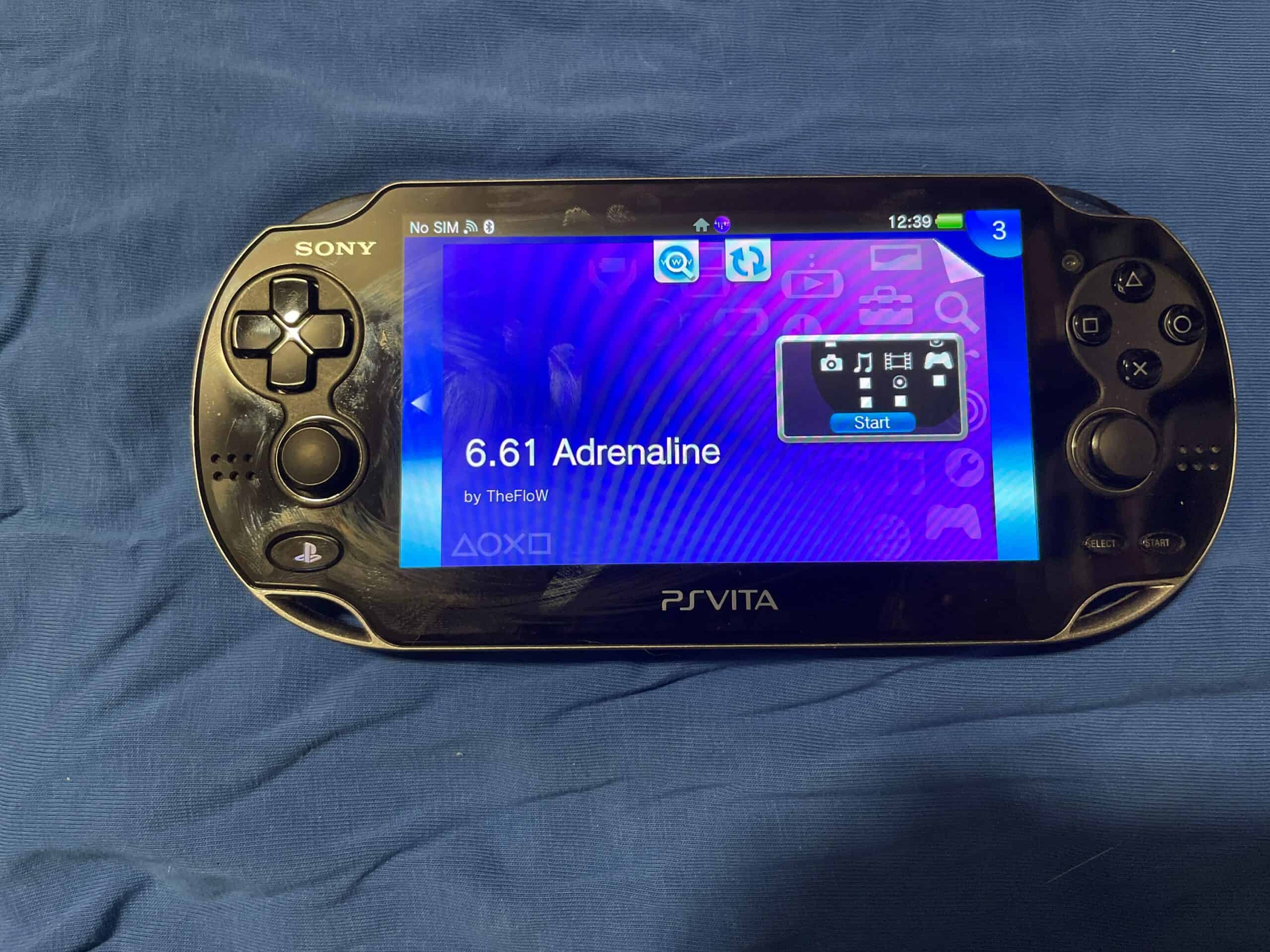 OLED Sony PS Vita portable gaming device with 28GB to 1TB storage options and homebrew capabilities.