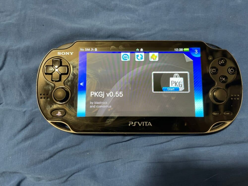 Sony PS Vita OLED handheld gaming console with screen and controls.