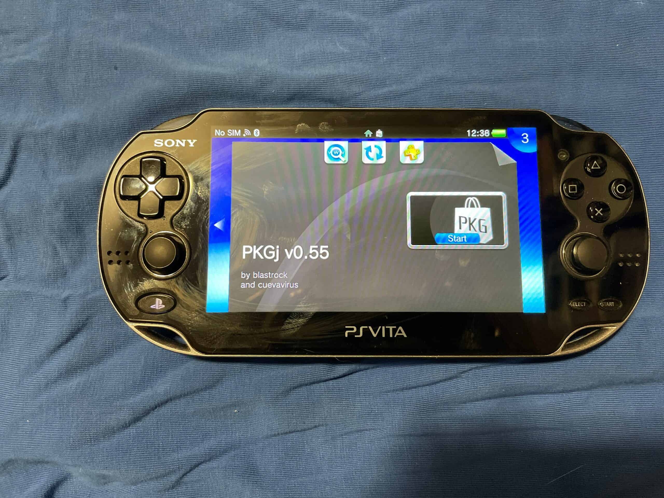 Sony PS Vita OLED handheld gaming console with screen and controls.