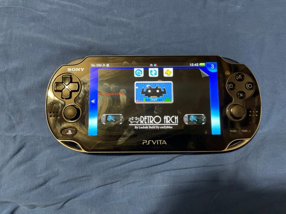 Sony PS Vita OLED Model 1000 handheld gaming console with custom firmware and extensive game library.