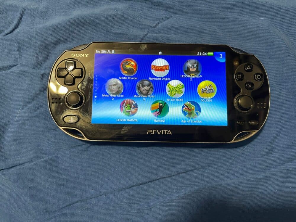 OLED Sony PS Vita 1000 handheld gaming console with customizable features and access to 8000+ homebr.
