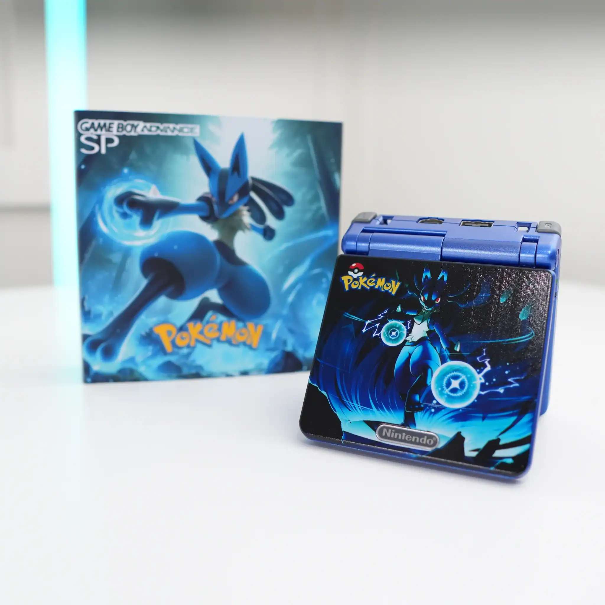 Enhanced Pokémon-themed GBA SP with IPS backlit mod and original box.