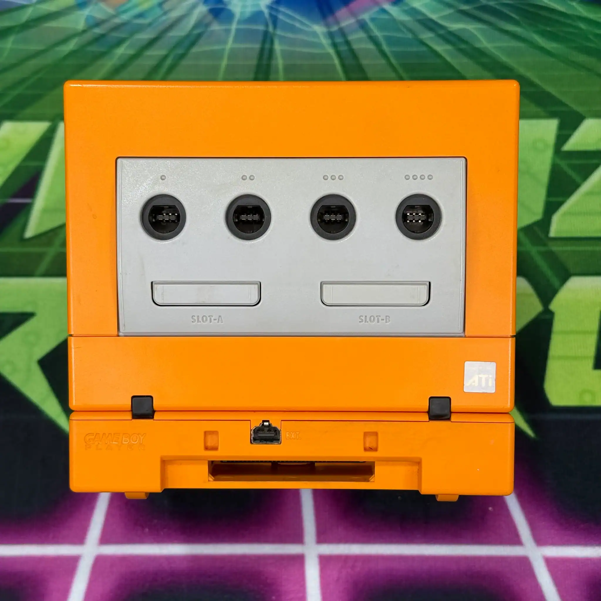 Modded GameCube console in vibrant spice orange color.