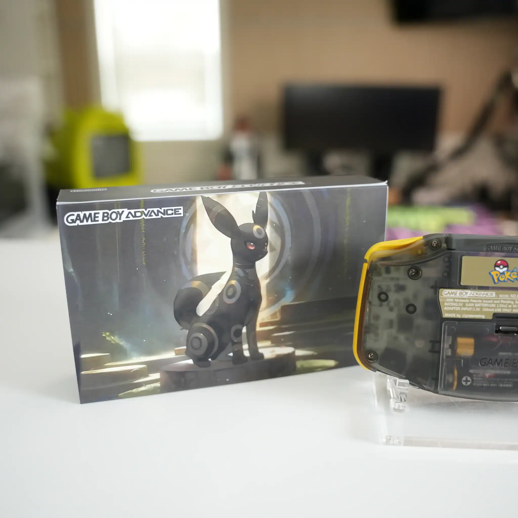 Umbreon-themed Nintendo Game Boy Advance GBA console with box and display stand.
