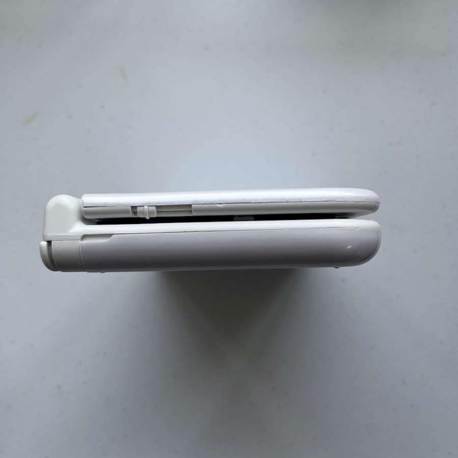 White Nintendo 3DS XL with 128GB storage, preloaded games, ready to play.