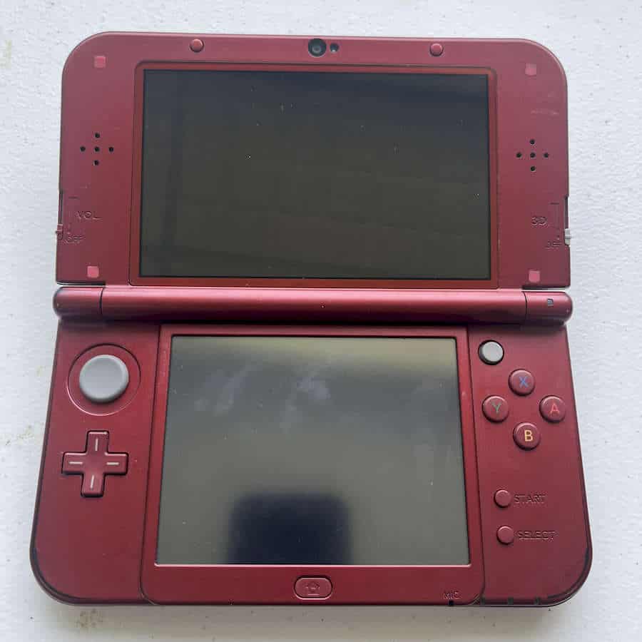 Red Nintendo 3DS XL with 128GB storage, preloaded games, ready to play.