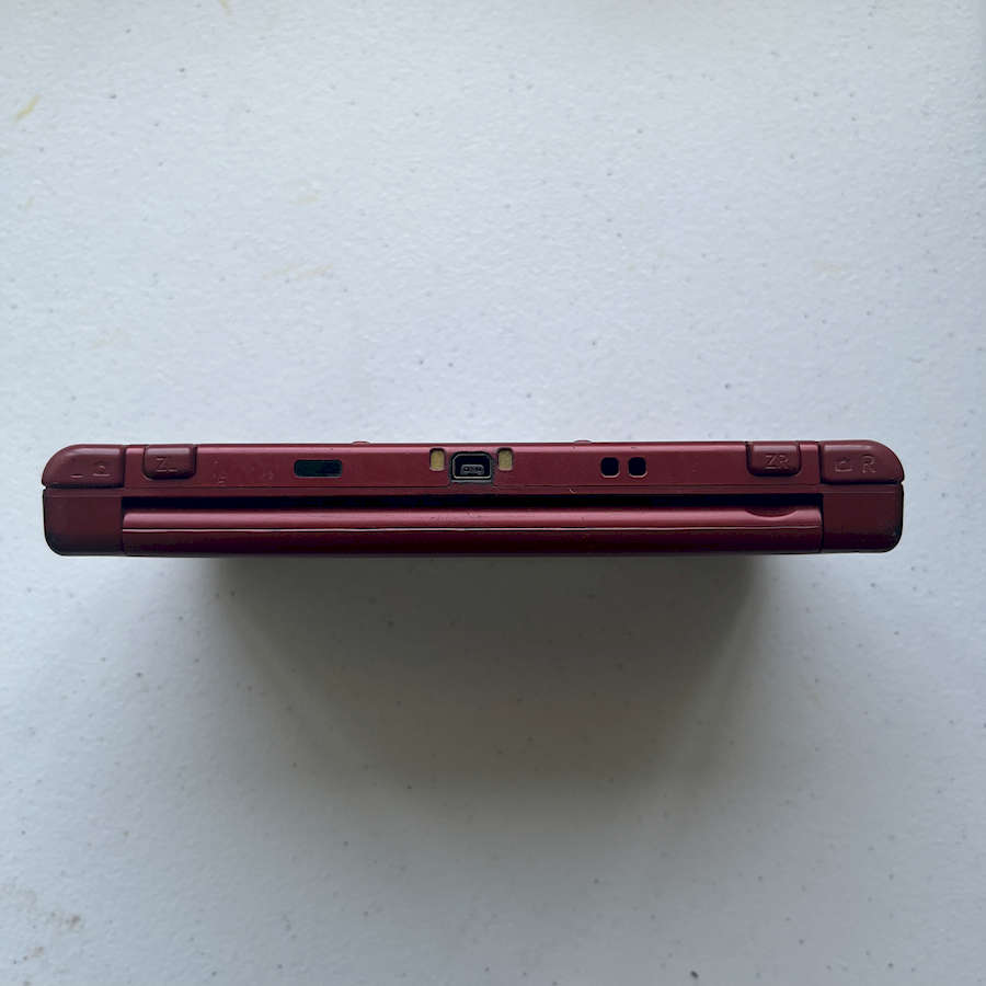 Red Nintendo 3DS XL console with 128GB preloaded storage.