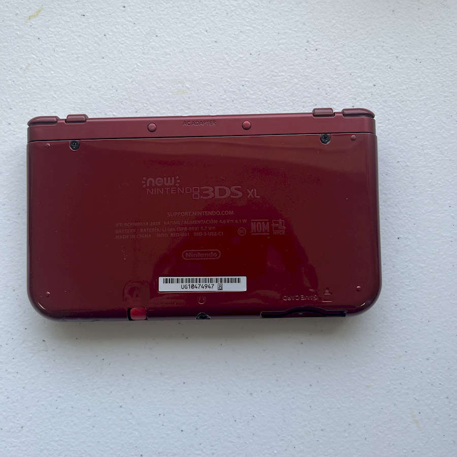 Red Nintendo 3DS XL gaming console with 128GB preloaded storage.