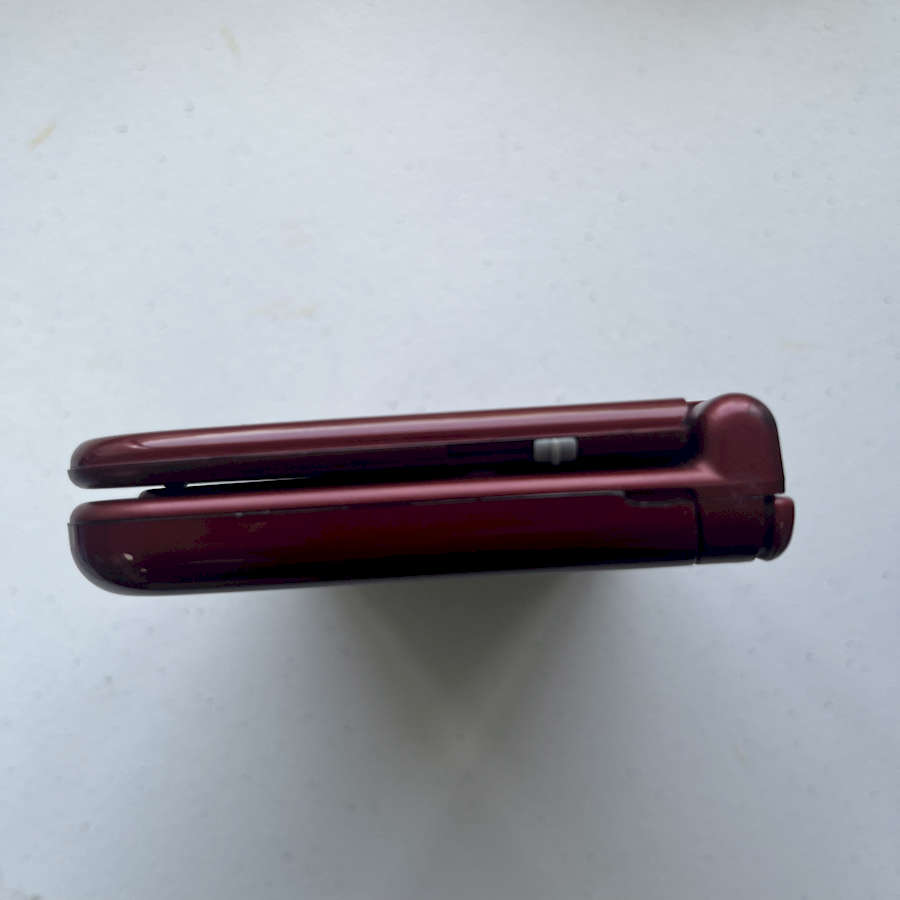 Refurbished red Nintendo 3DS XL with 128GB preloaded for gaming.