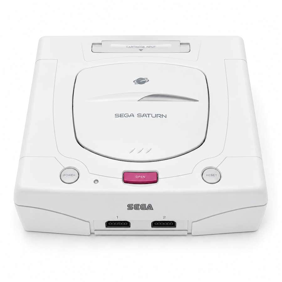 White SEGA Saturn console with pink open button and dual controller ports.
