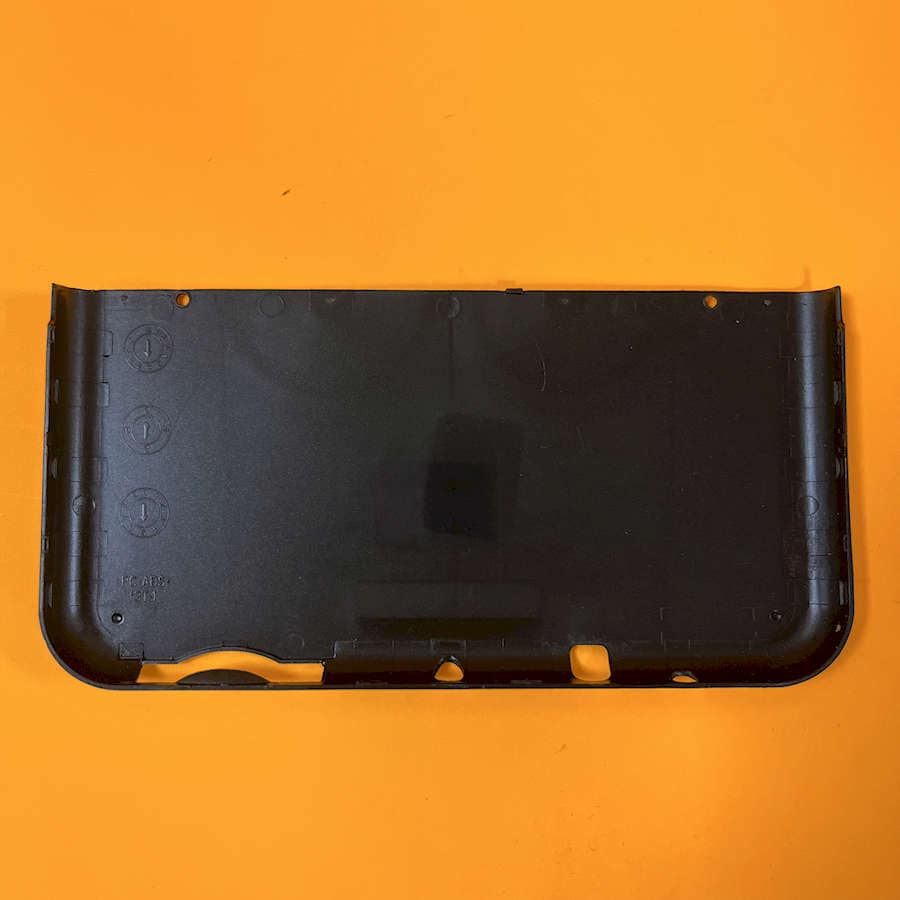 Black Triforce style shell cover for Nintendo 3DS XL on orange background.