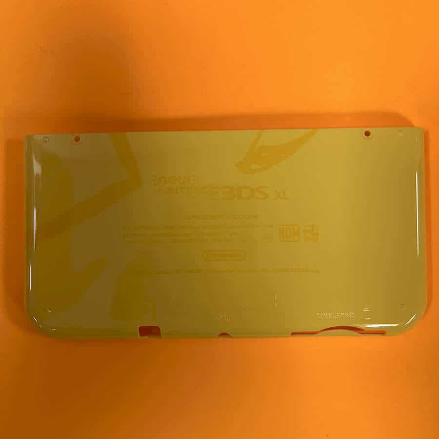 Yellow Pikachu-themed shell cover for Nintendo 3DS XL console.