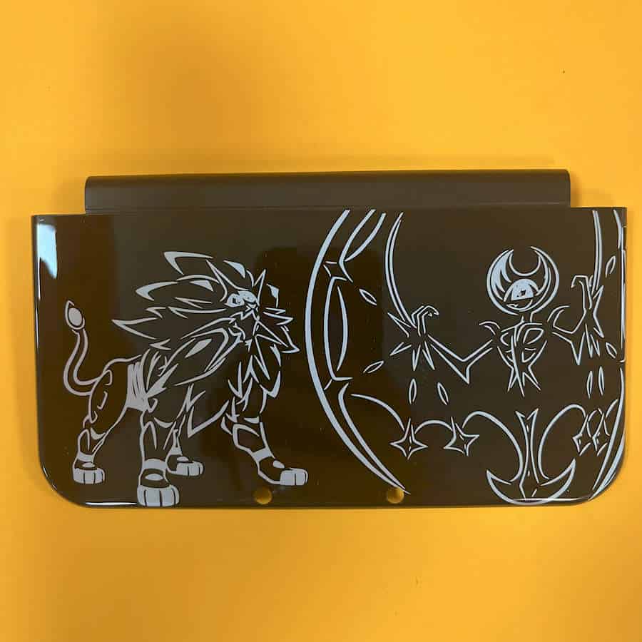 3DS XL shell cover with Pokemon Sun & Moon design featuring a lion and a fairy.