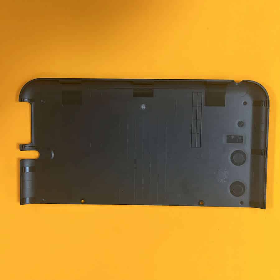 Black Nintendo 3DS XL Charizard edition back shell cover on orange background.