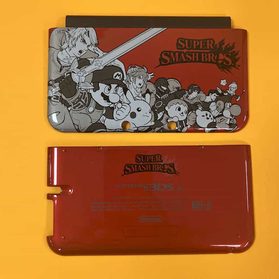 Red Nintendo 3DS XL shell with Super Smash Bros design for gaming console.