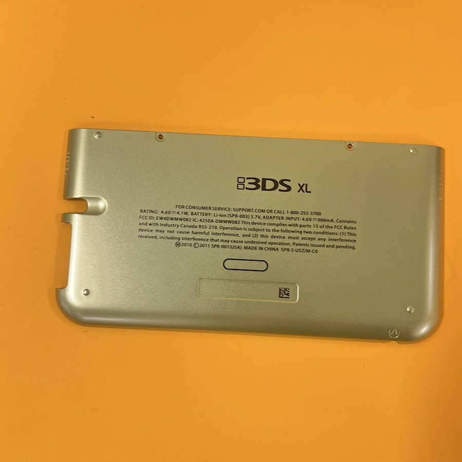 Gold Nintendo 3DS XL shell with back cover and branding.