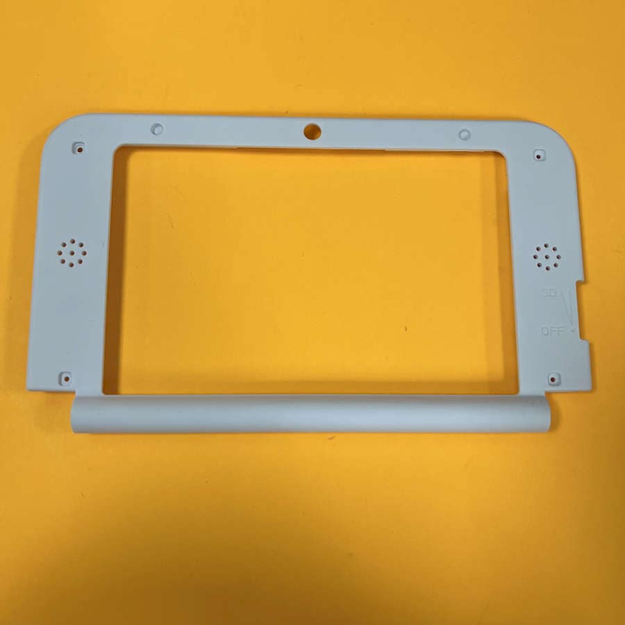 Black top frame for Nintendo 3DS XL console, brand new, on yellow background.