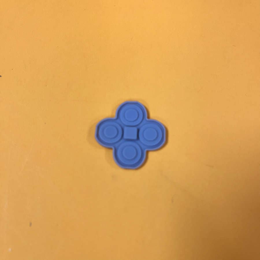 Blue rubber pad for 3DS XL ABYX buttons on yellow background.