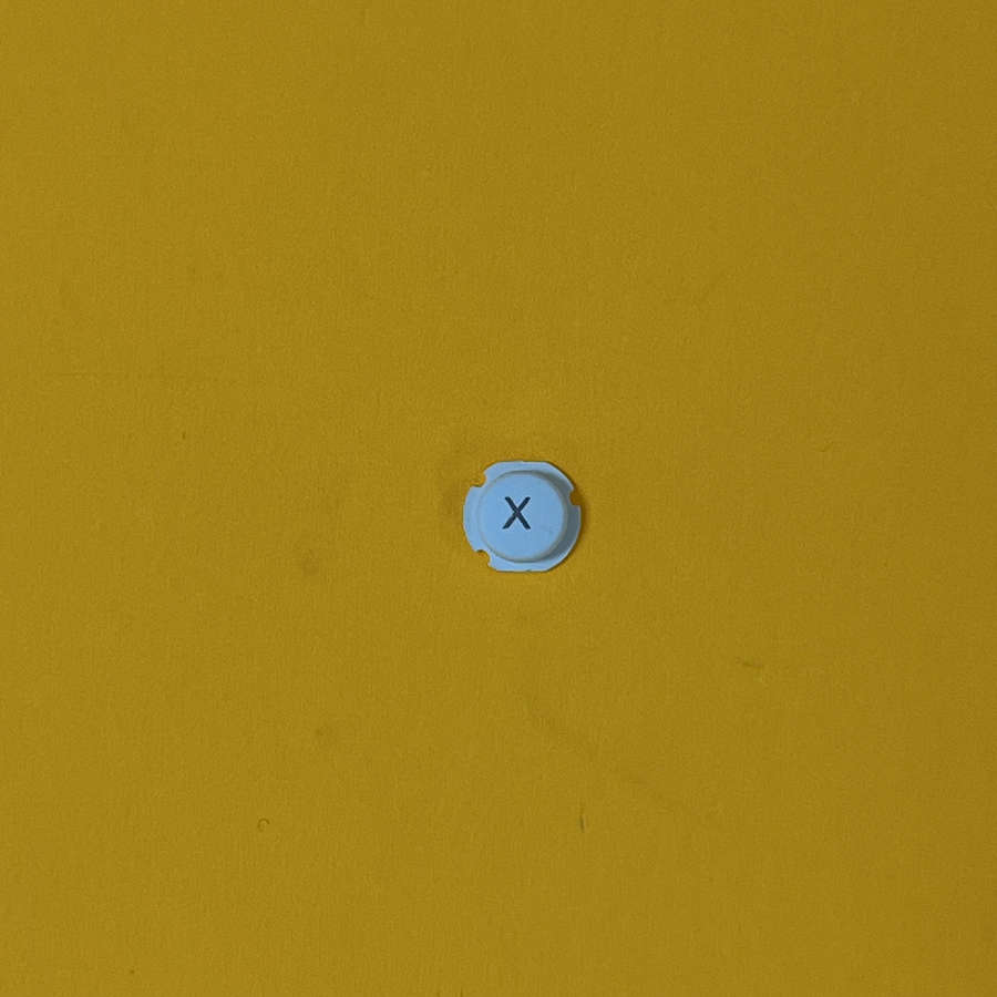 Blue X button for Nintendo 3DS XL replacement part on yellow background.
