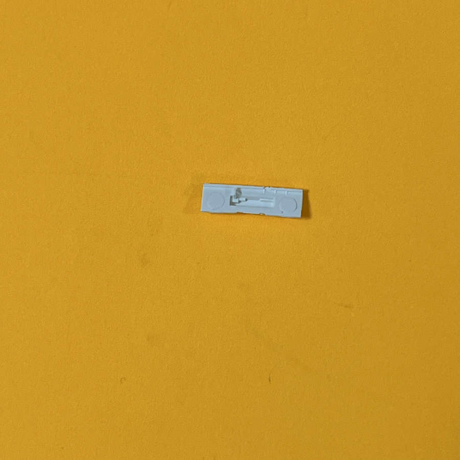 White volume slider switch for Nintendo 3DS XL on yellow background.