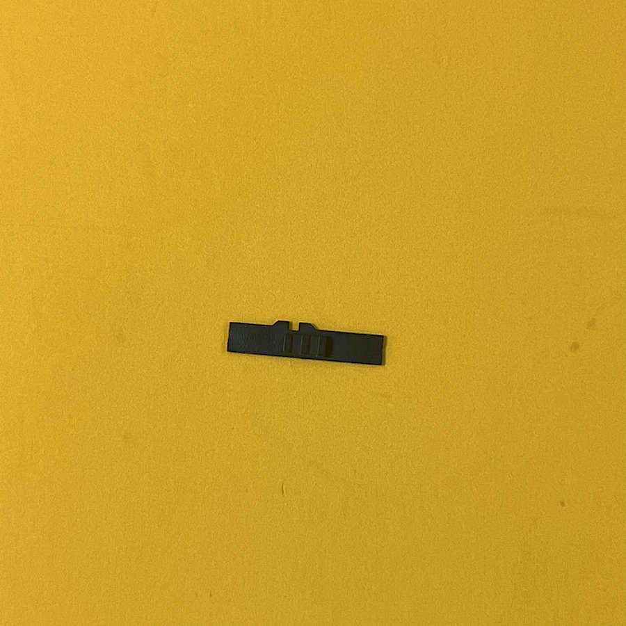 White volume slider replacement part for Nintendo 3DS XL on yellow background.