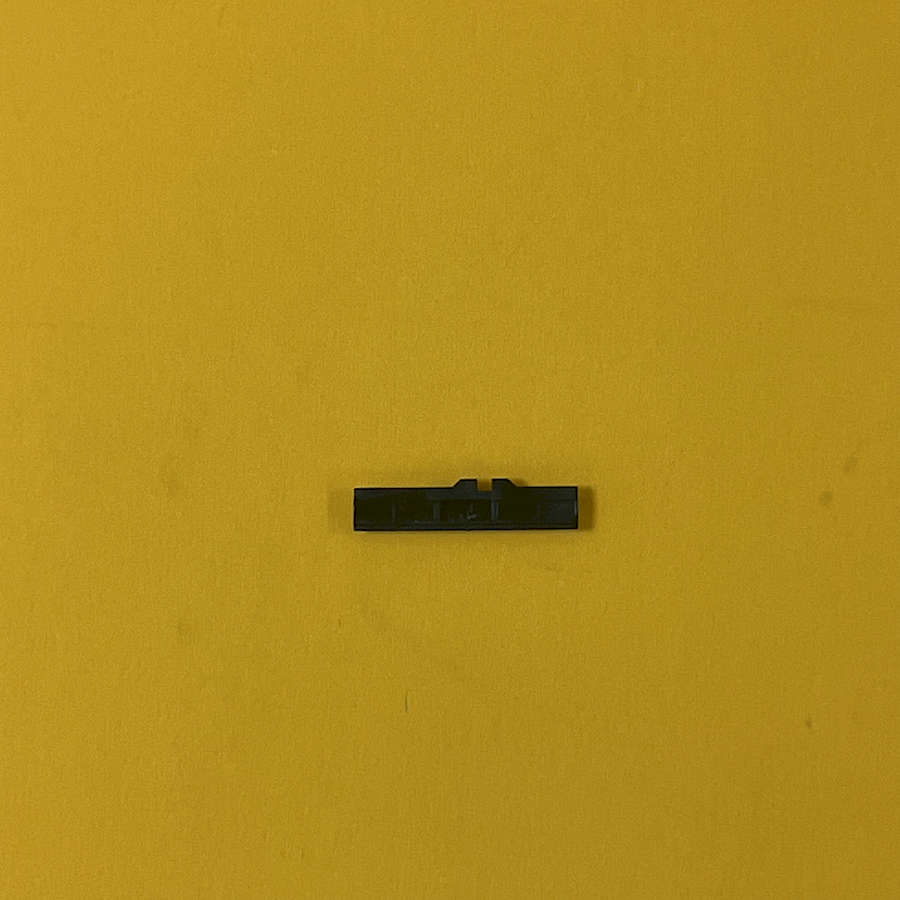 Black volume slider switch for Nintendo 3DS XL on yellow background.