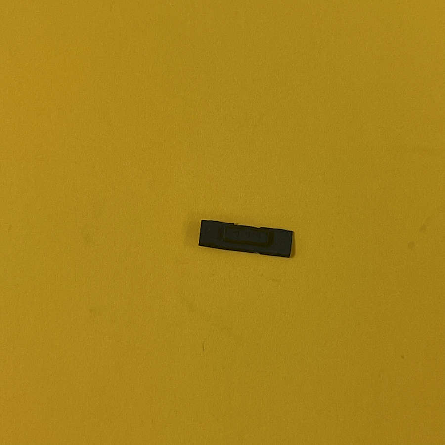 Black Wifi slider replacement part for Nintendo 3DS XL on yellow background.
