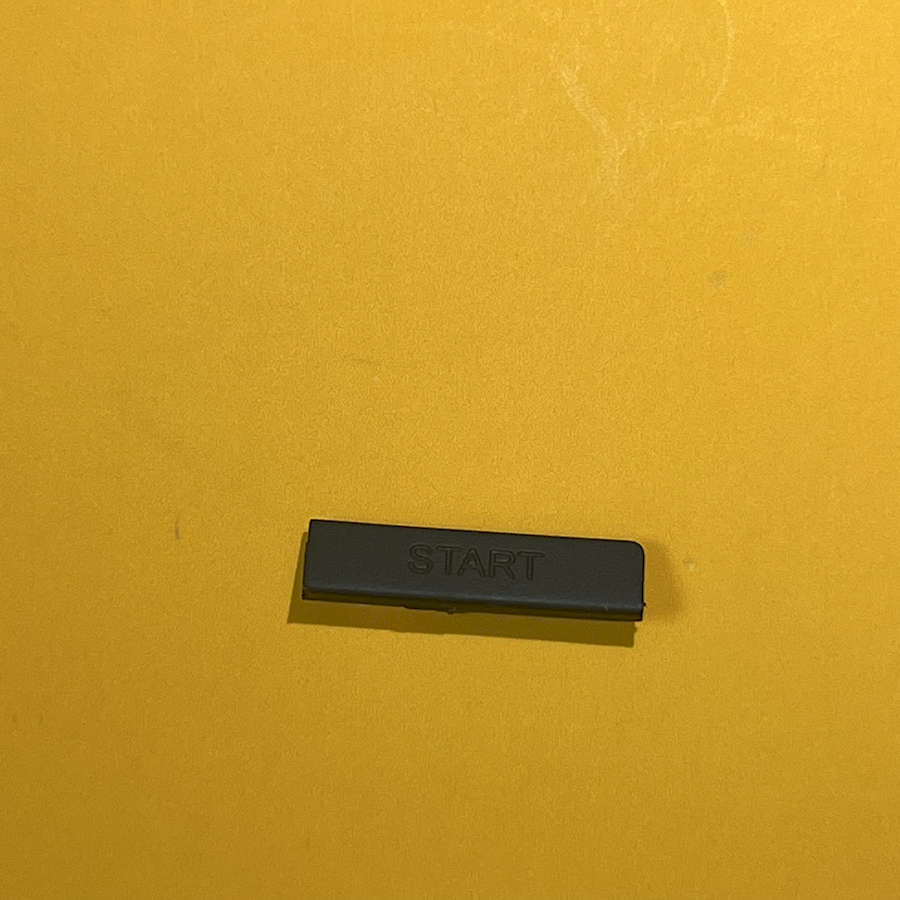 Black start button for Nintendo 3DS XL gaming console.