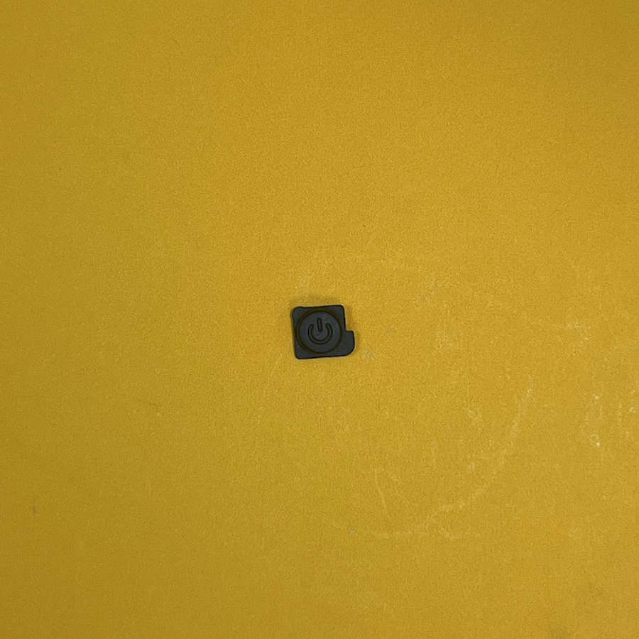 Black Y Button for Nintendo 3DS XL on yellow background.