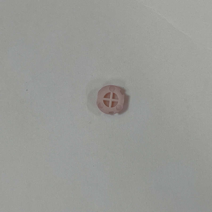 Pink Nintendo 3DS action button replacement on white background.