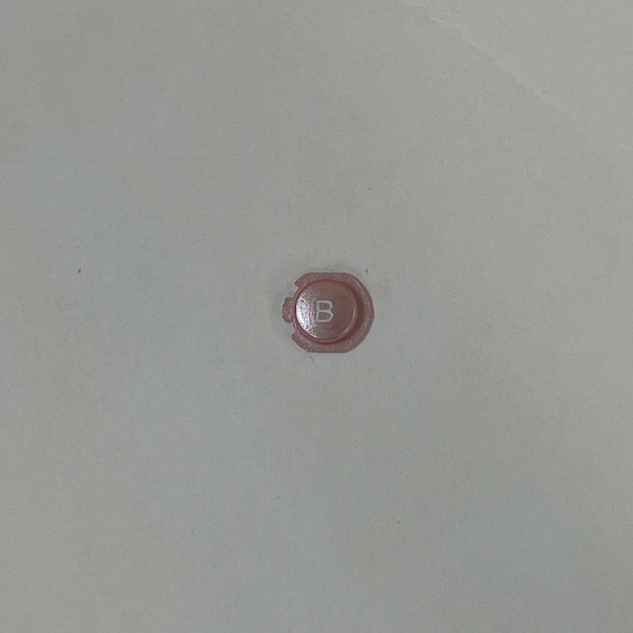 Pink Nintendo 3DS B button replacement for gaming controller.