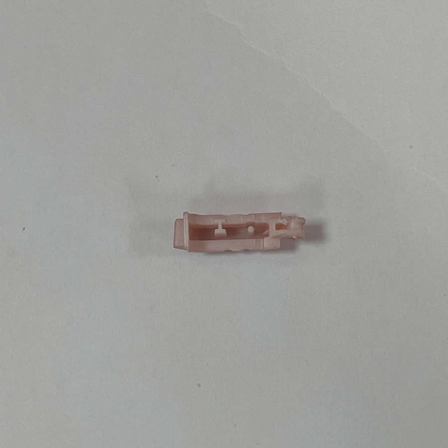 Pink Nintendo 3DS shoulder button replacement part on white background.