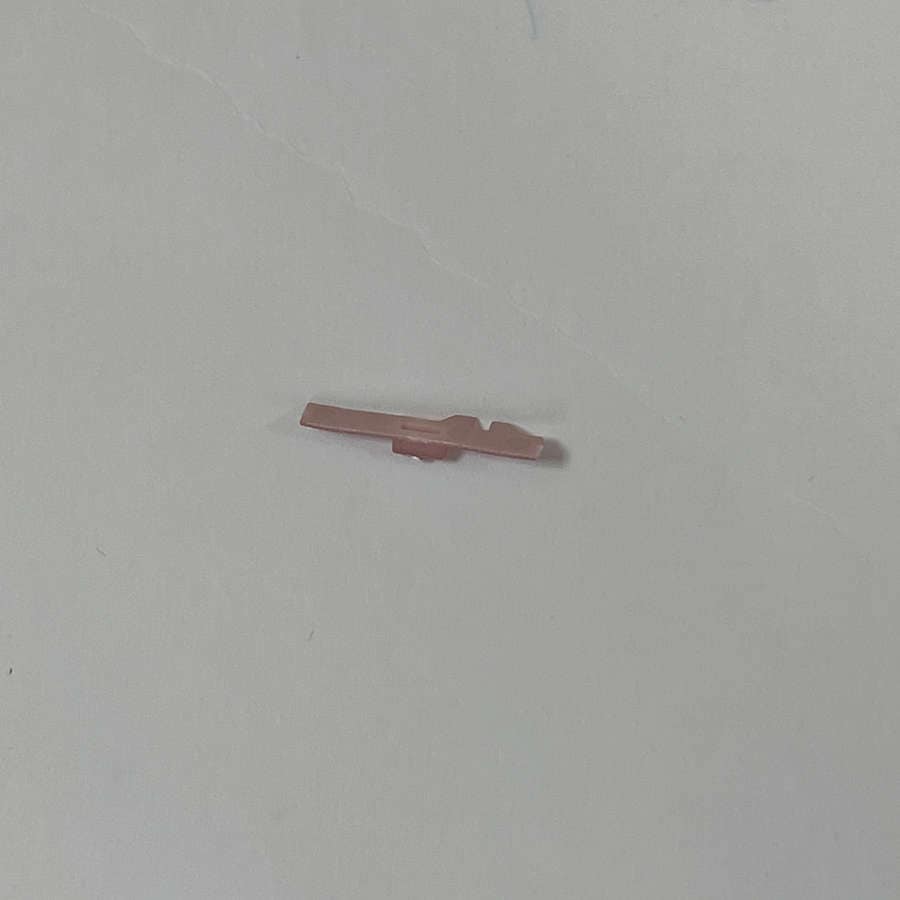 Pink Nintendo 3DS volume slider replacement part on white background.
